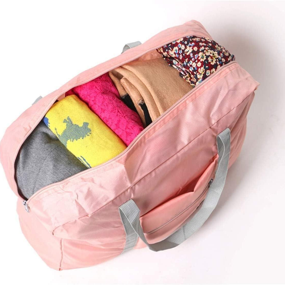 Foldable travel waterproof duffel bag in pink, black, and mint green