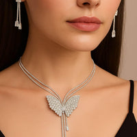 Butterfly necklace and earrings on a model against a neutral background